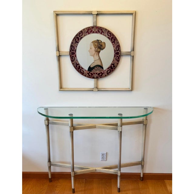 This elegant and unusual Italian Renaissance style console and matching mirror likely date to the 1940s. The wood frames...
