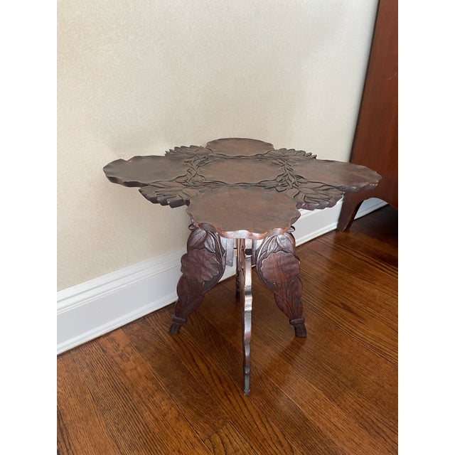 This stunning carve table is balance between asian and art nouveau with carvings of lotus leaves and flowers. The carvings...