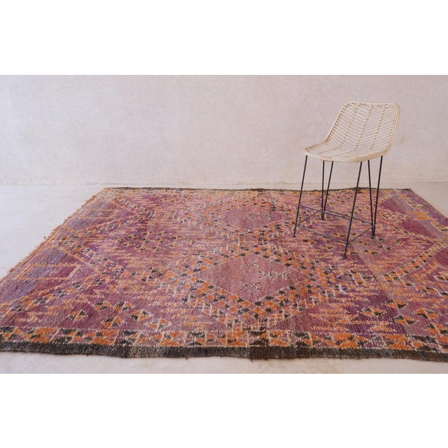 Elevate your home decor with this unique and timeless Moroccan Beni MGuild rug. Measuring at 10.5 x 7 ft, this piece of...