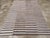 This mid-20th century Turkish flatweave kilim rug, features a lively horizontal stripe design arranged across three...