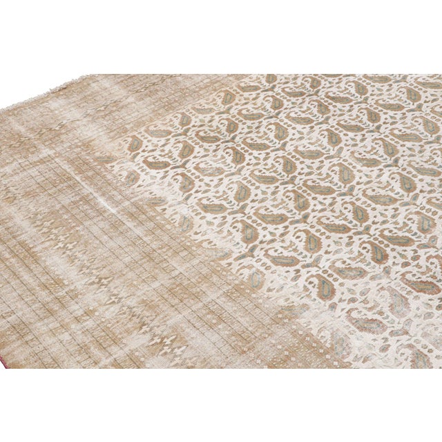 Hand knotted in Pakistan originating between 1880-1890, this antique wool rug enjoys one of the most uncommon variations...