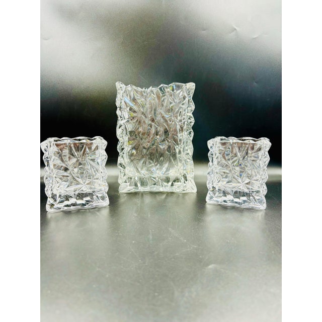 Add sparkle and sophistication to your décor with this striking set of three cut crystal vases/vessels in the iconic...