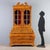 Walnut and burl walnut trumeau. Glass-door cabinet with a central drop-down door concealing a four-drawer cabinet, the...