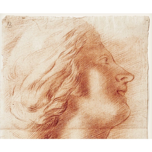 A beautifully executed antique French portrait study rendered in warm sanguine Conté crayon on handmade paper. Depicting a...