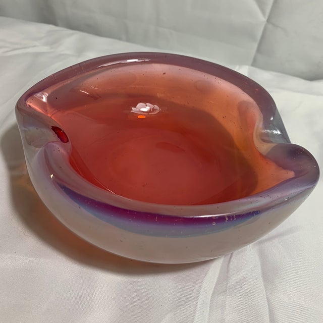 Offered here is a murano dish with a fuchsia core inside an opalescent milky-white or lavender-tinted outer glass casing....