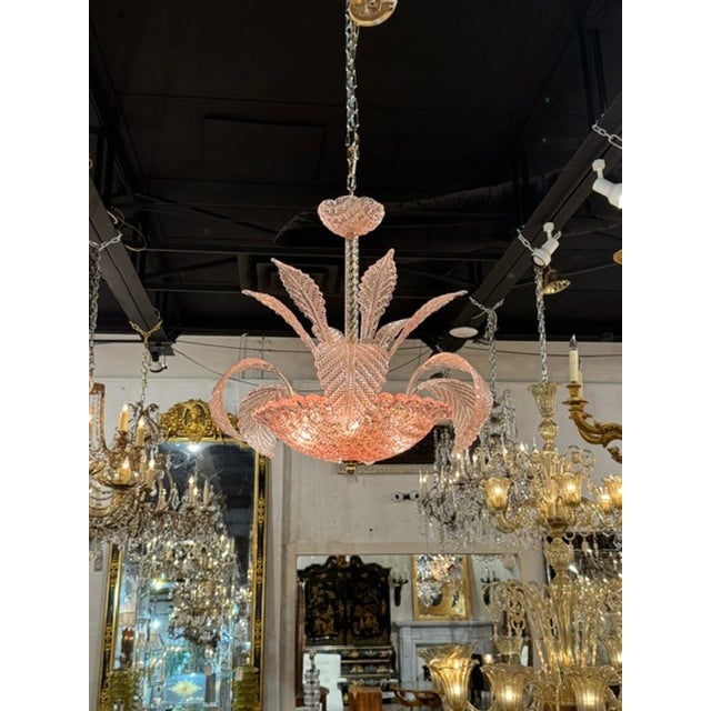 This Pink Murano Glass Leaf Chandelier is a stunning and unique lighting fixture that adds a touch of elegance and beauty...