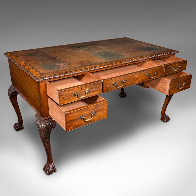 This is an antique master shipping clerk's desk. An English, mahogany and leather partner desk, dating to the Edwardian...