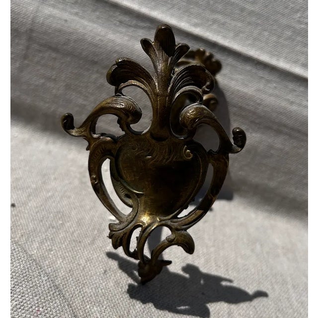 A pair of French antique tie backs cast in brass in an antique bronze finish. These are perfect in guest bathrooms for...