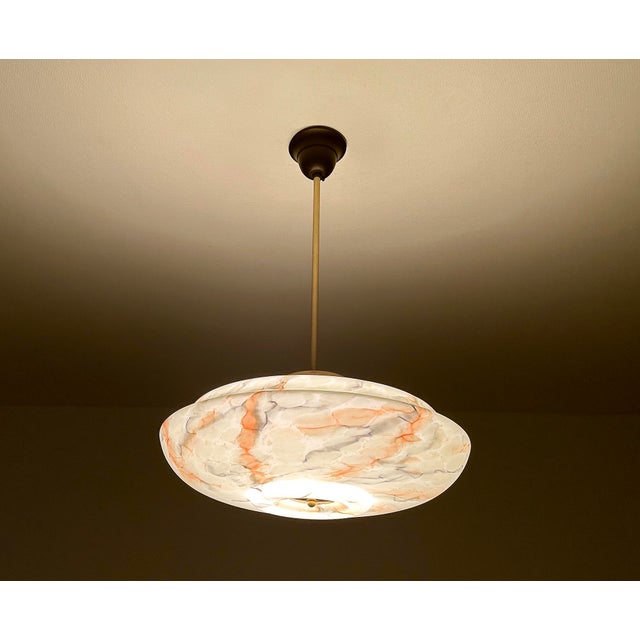 Art Deco pendant lamp with a jade green marble glass shade with orange charcoal veins, brass glass cover, burnished brass...