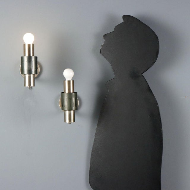 Wall lamps dating back to the 1960s, featuring a structure in chrome-plated metal and enameled aluminum. These lamps...