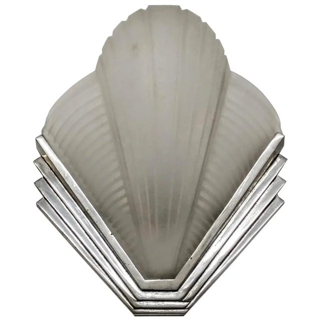 A pair of French Art Deco wall sconces by the French artist " Petitot " in clear frosted glass with vertical and...