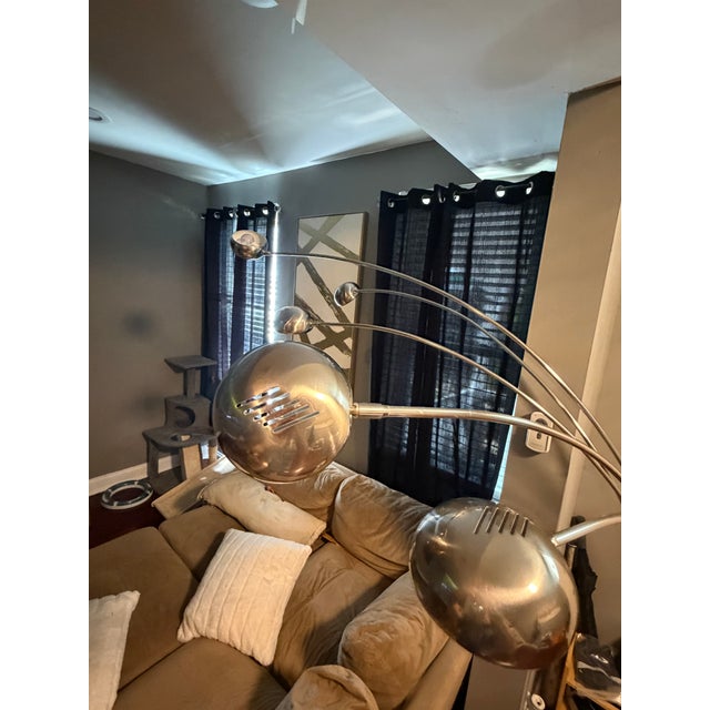 Vintage chrome arc floor lamp with five adjustable lights and a solid white marble base. Features a sleek mid-century...