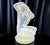 "Lalique – Floreal" is a mid-20th-century frosted and opalescent glass artwork. It depicts a kneeling nude woman,...