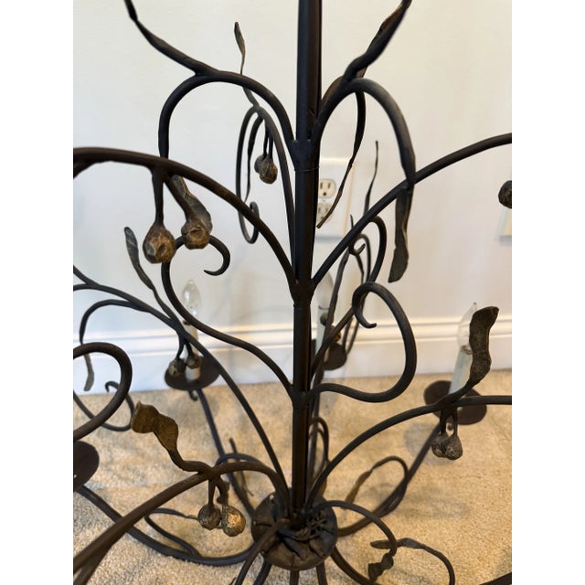 Gorgeous 8 light chandelier by Ironware International, featuring organically shaped branches and leaves that become a...