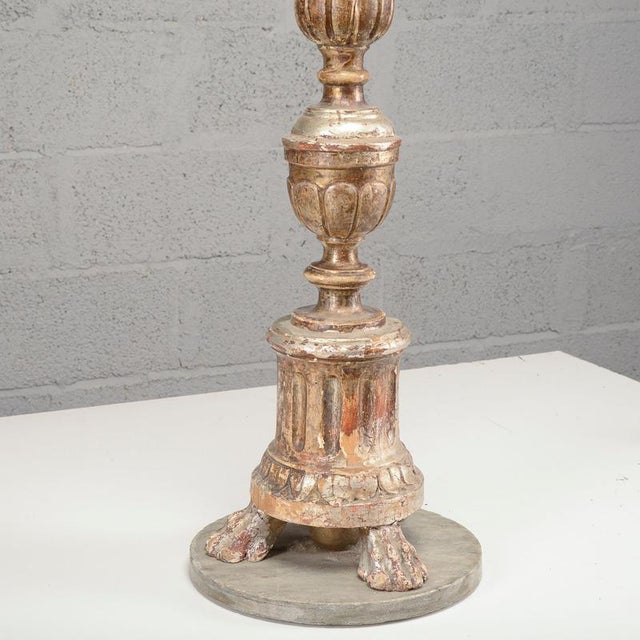 This finely carved candlestick is a refined example of an antique, characterized by the classic elegance of a bygone era....