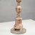 This finely carved candlestick is a refined example of an antique, characterized by the classic elegance of a bygone era....