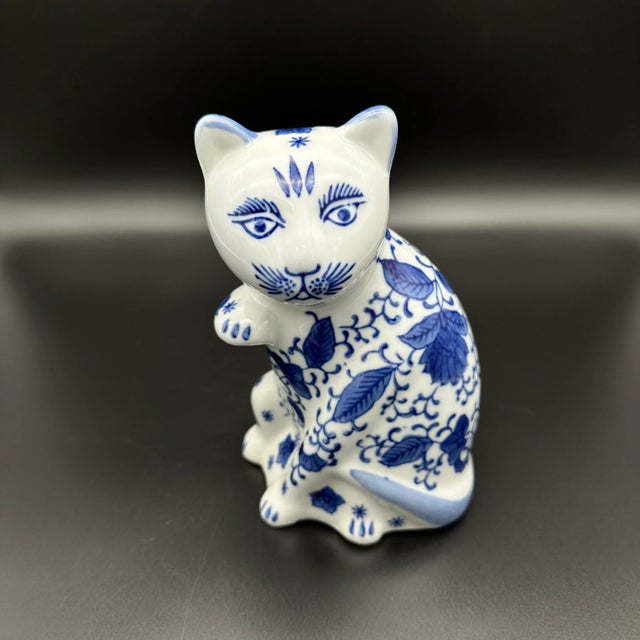 Add a touch of elegance to any collection with this vintage blue and white Chinoiserie porcelain cat figurine with hand-...