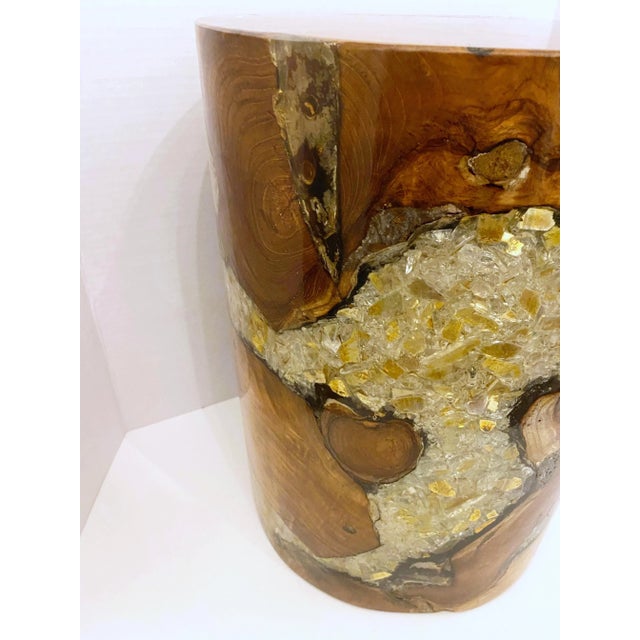 Organic modern round stool in natural and teak wood with cracked resin design. Polished finish with unique wood variations...
