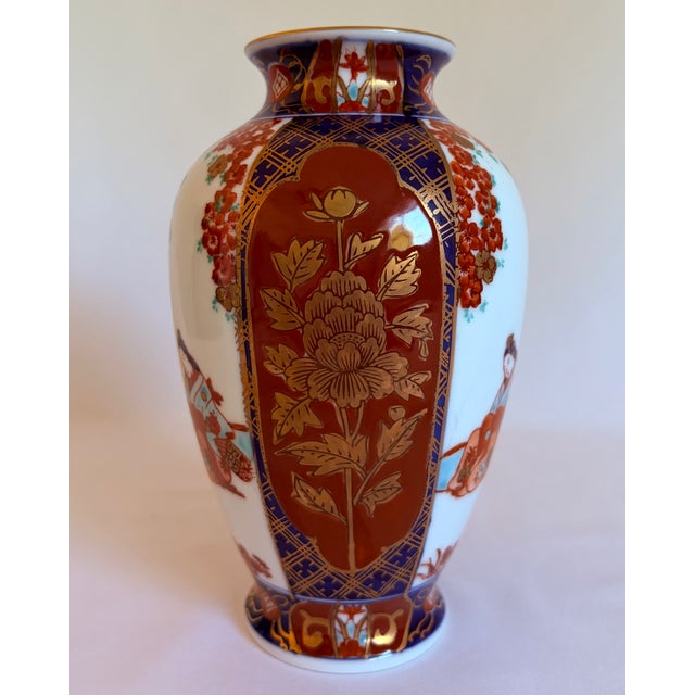 Richly decorated vintage Japanese porcelain vase by Gold Imari, featuring alternating figural and floral panels in a...