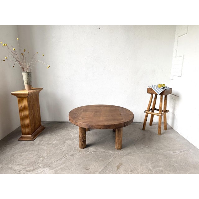 A round, Brutalist coffee table from the 1950s, crafted from solid pine, in a modernist aesthetic. This unique piece is...