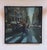 This oil on panel artwork captures a bustling urban scene, where pedestrians navigate a busy crosswalk amidst the blurred...