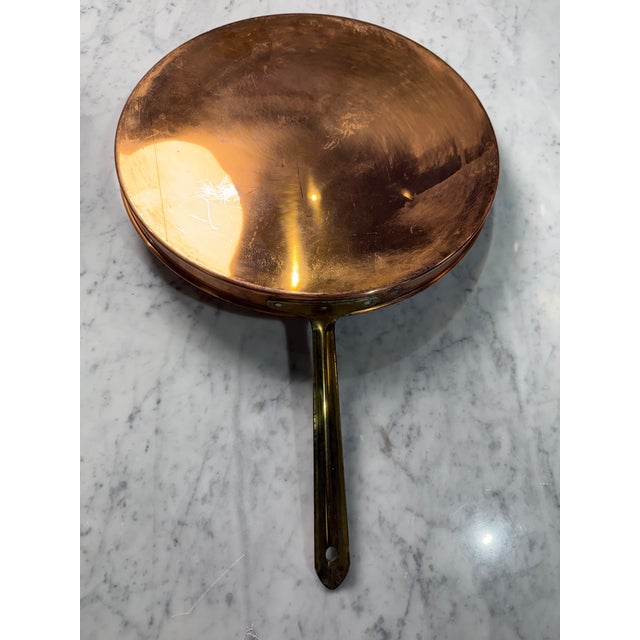 A beautifully crafted vintage Italian copper crêpe pan that embodies the warmth and enduring appeal of traditional...