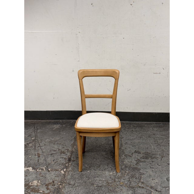 Design Plus Gallery presents a Upholstered Cline Dining Chair from Pottery Barn. This chair pairs a light wood frame with...