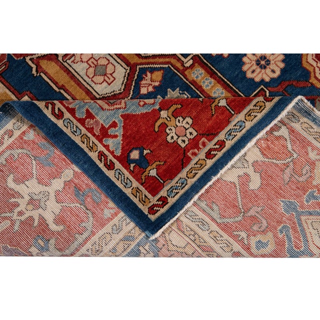 Beautiful Vintage Turkish hand-knotted wool rug with a blue field. This rug has a designed blue frame with multicolor...