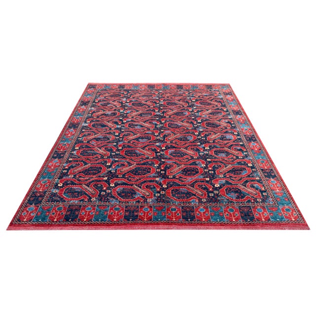 Add bold character and timeless charm to your interior with this hand-knotted tribal rug, showcasing a striking paisley...