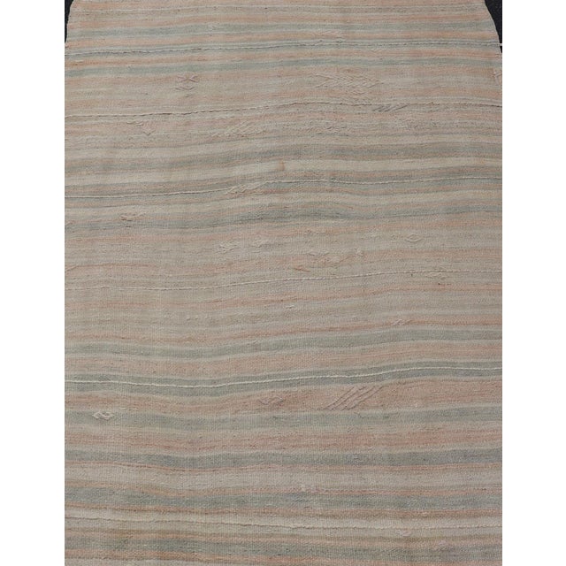 Vintage Turkish Kilim Rug with Soft Pastel Stripes and Earthy Tones Measures: 4'11 x 7'7 This vintage Turkish kilim rug...