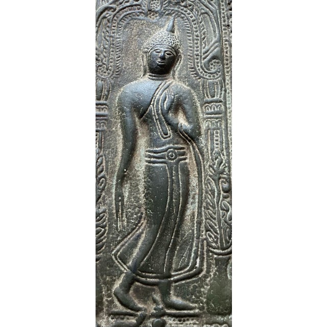 This exquisite antique Sukhothai-style Thai Buddhist metal votive plaque features intricate, detailed relief work...