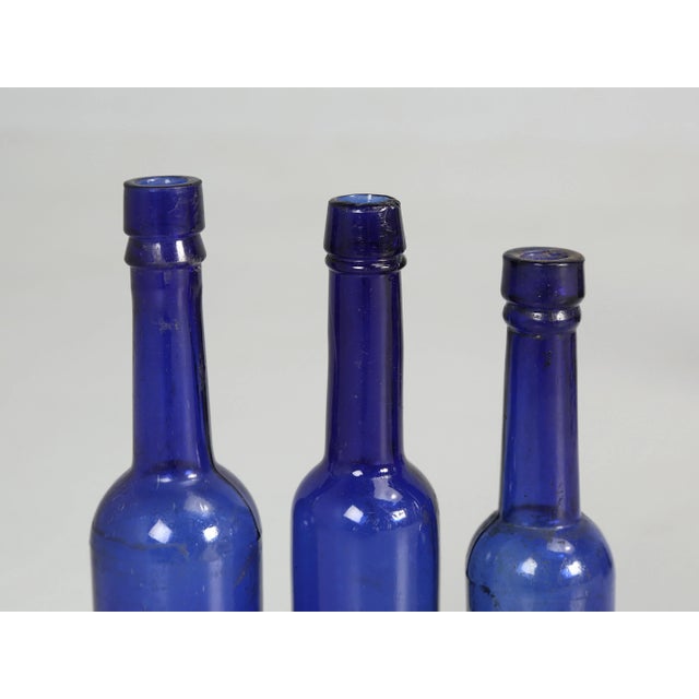 Collection of '15' Cobalt Blue Caster Oil Hand Blown Bottles Made in 1800s For Sale - Image 10 of 12