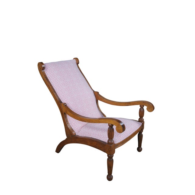 Intriguing early 20th century British Colonial style plantation chair. Features an oak frame with traditional lounging...