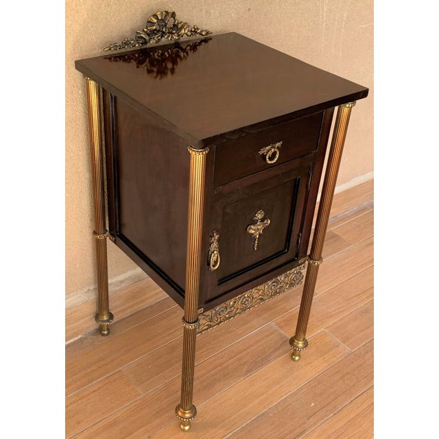 About Elegant, timeless pair of French modern neoclassical ebonized mahogany with 1 drawer and 1 door. You can use like an...