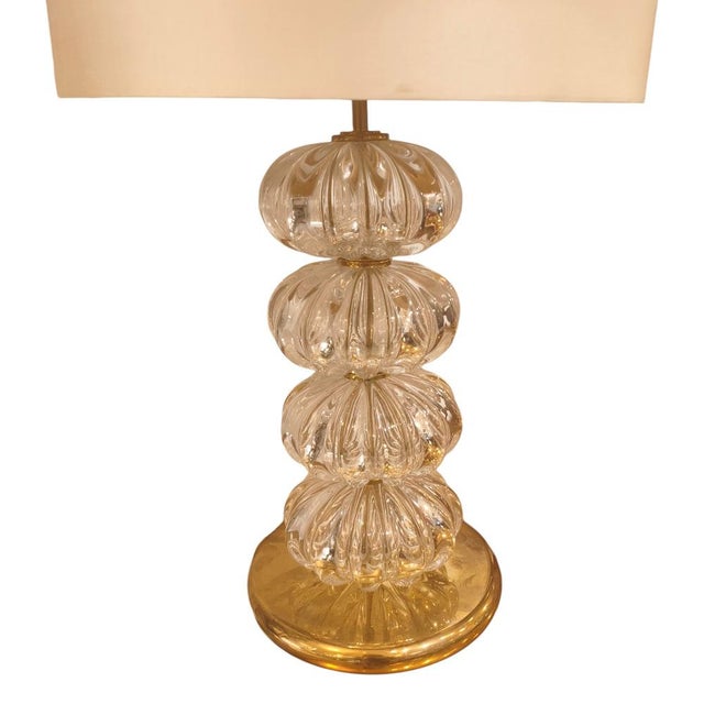 A spectacular pair of lamps with an elegant body composed of four fluted Murano glass spheres. Each sphere has a grooved...
