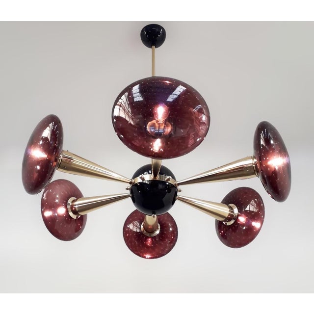 Italian chandelier with Murano glass shades, mounted on polished brass frame with black enameled center and ceiling canopy...