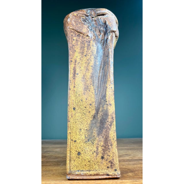 Heavy and durable abstract arts and crafts style pottery vase. Slender form in earthy colors of tan and brown.