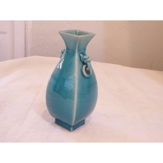 This crackle glaze ceramic vase measures 9.5"H x 4"W.