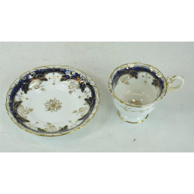 This antique tea cup is made of fine bone china in cobalt blue and gold with hand-painted details. It features a design...