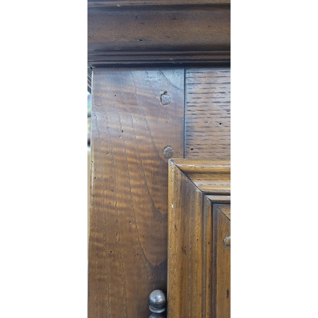 Beautiful antique large French carved walnut armoire. Features crown molding carved doors with flowers and stars, a single...
