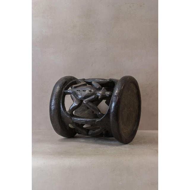 This Baule wood carved vintage stool is a stunning piece of traditional African craftsmanship. Hand-carved from solid wood...