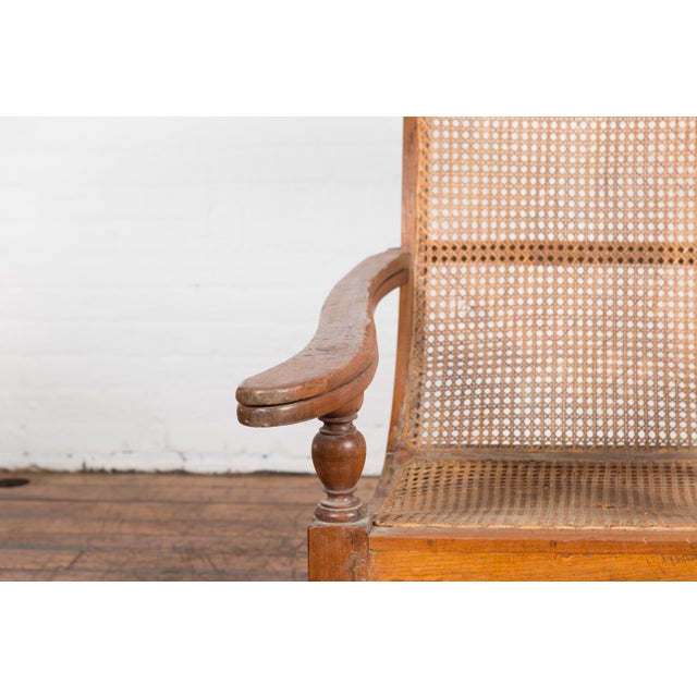 Brown Dutch Colonial Indonesian Cane and Wood Plantation Chair with Extending Arms For Sale - Image 8 of 12