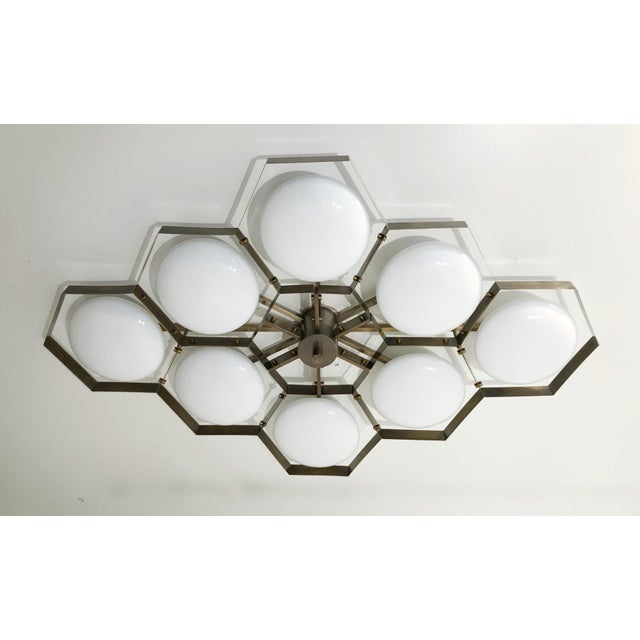 Italian midcentury flush mount with eight glossy white Murano glass shades mounted on solid brass frame in bronze finish /...