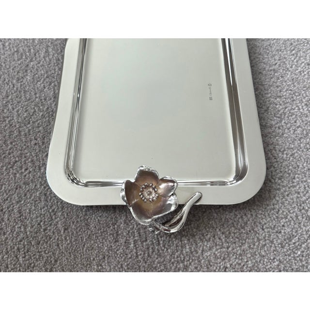 This small silver plated rectangular tray by Christofle France features an elegant handle fashioned after a fully bloomed...