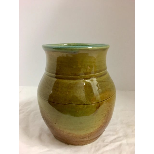 Vintage polished Carmel color ceramic vase with an aqua green interior.