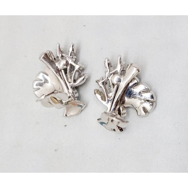 1950s rhodium plated small round clear rhinestones floral spray clip earrings. Marked "PENNINO" on the clip backs....