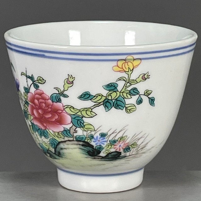 This is a charming vintage porcelain teacup, decorated in the wucai palette with vibrant polychrome enamels. The cup...
