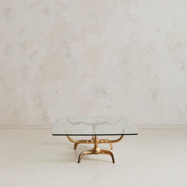 A rare low coffee table by Romanian-born sculptor Victor Roman, cast in solid bronze with a hand-polished finish. The...