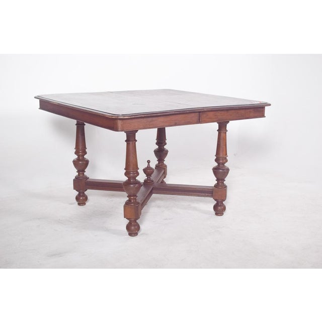 Oval-top table. With a folding structure and an ovalised shape when open, it features a dark wood that combines robustness...