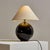 A textile shaded table lamp with a brass base and stem from the 1970s. The lamp’s body is made of glass, making it an...